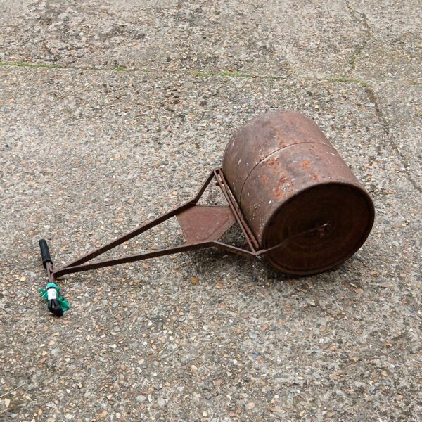 Vintage cast iron garden roller for lawn care.