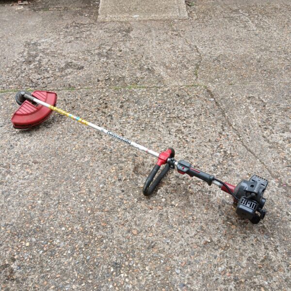 Kawasaki KBL23A petrol grass strimmer for garden maintenance.