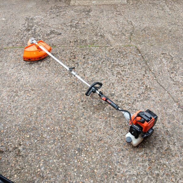 Unbranded petrol grass strimmer for garden and lawn maintenance.
