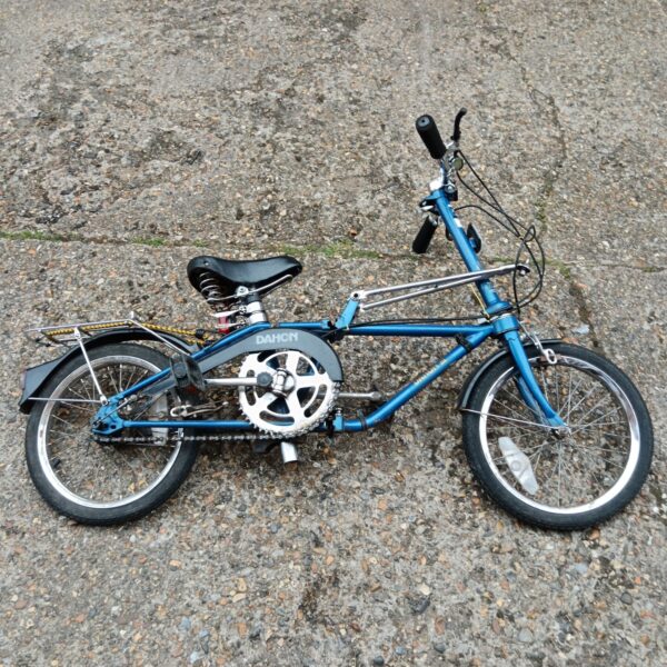 Vintage Dahon folding bicycle in blue, side view.