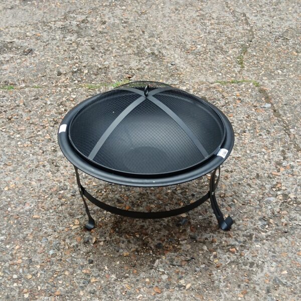 Small metal garden fire pit with mesh spark guard.
