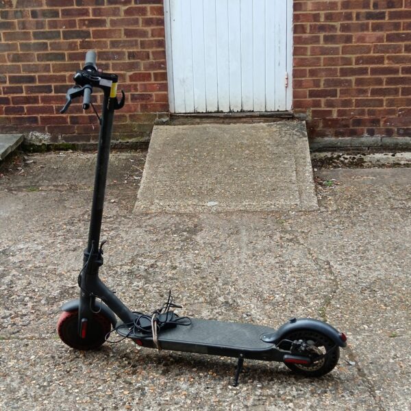Black electric scooter with no acceleration, ideal for repair.