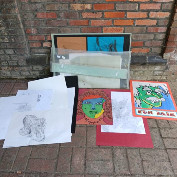 Collection of original artwork and sketches inside a folder.