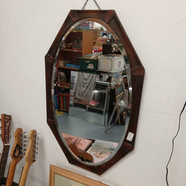 Vintage copper bevelled mirror with octagonal frame.