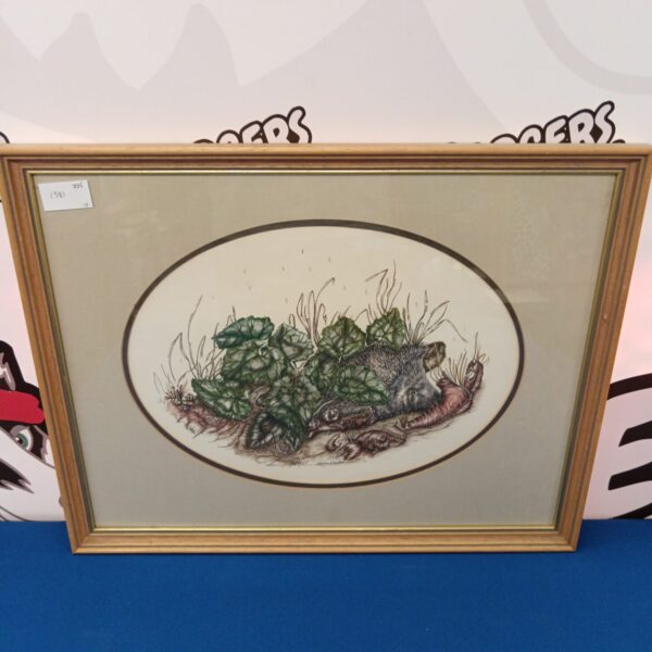 Framed Christina Woodley hedgehog painting with foliage detail.