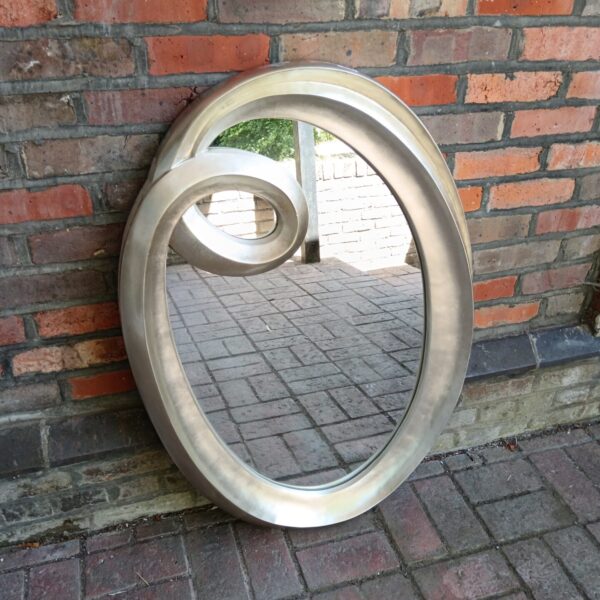 Large silver tone spiral mirror for modern home decor.