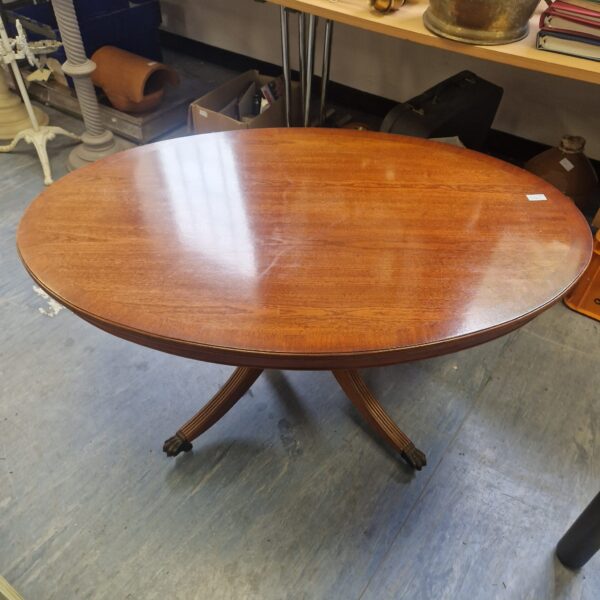 Vintage oval coffee table with claw feet.