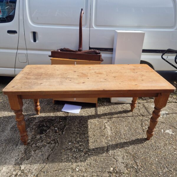 Large pine dining table with rustic charm and farmhouse style.