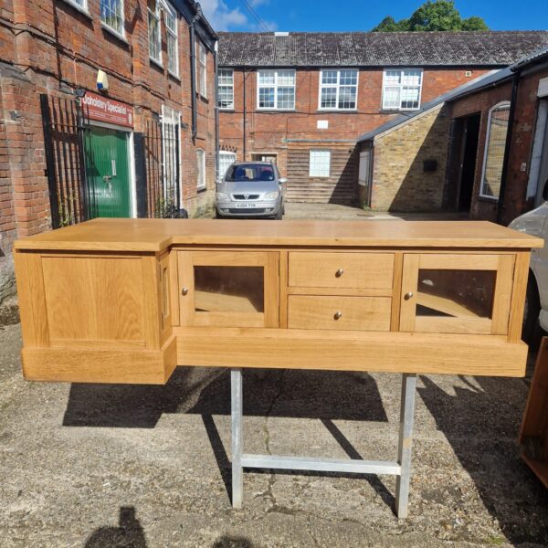 Vintage oak media cabinet with doors and ample storage space.