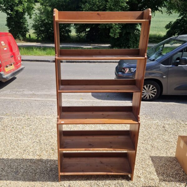 Vintage six-tier pine shelving unit for storage and display.