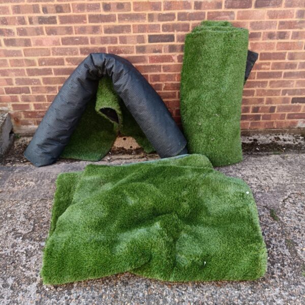 Bundle of three astro turf rolls for garden landscaping.