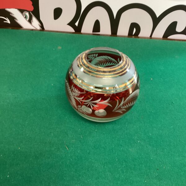 Vintage cranberry glass vase with intricate Bohemian cut glass details.