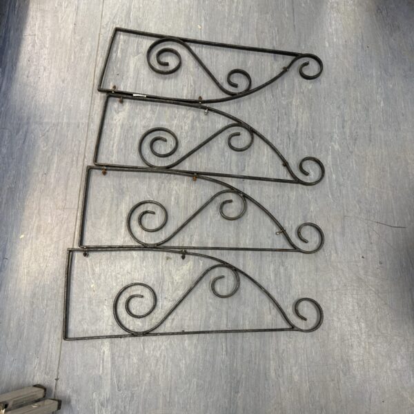 Set of four vintage wrought iron hanging basket brackets.