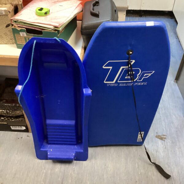 Blue plastic bodyboard sledge with pull cord for winter fun.