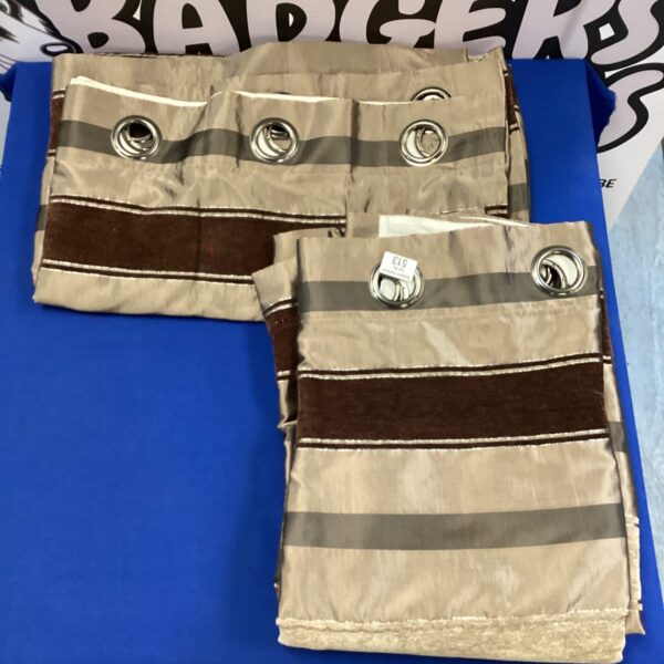Pair of bronze and brown patterned curtains with eyelet headings.