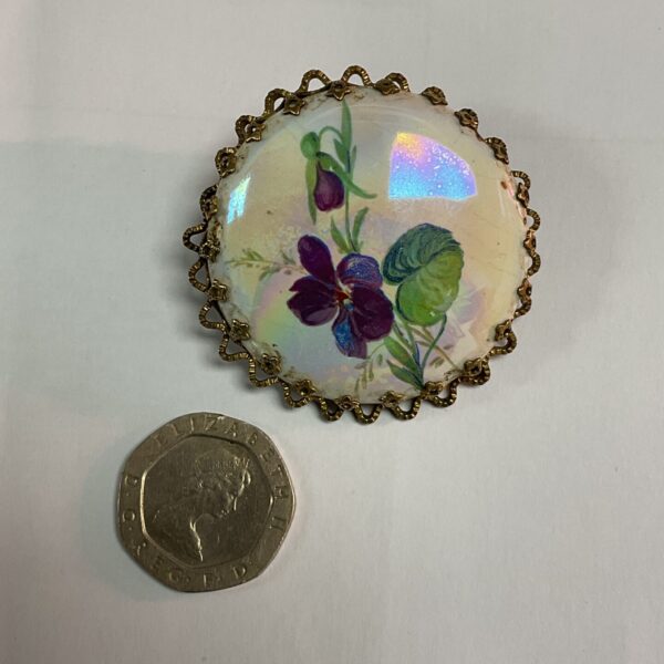 Delicate French porcelain brooch with hand-painted floral design.