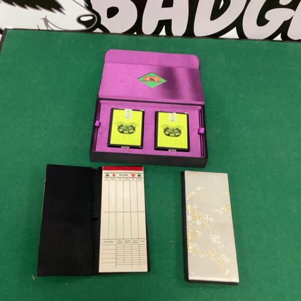 Vintage bridge card game set with floral card backs.