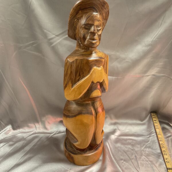 Hand carved wooden sculpture of a kneeling figure, folk art.