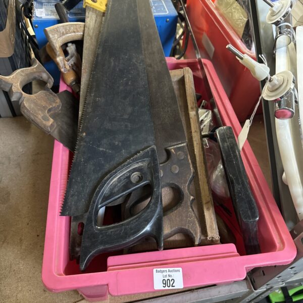 Mixed lot of vintage hand saws and tools for DIY projects.