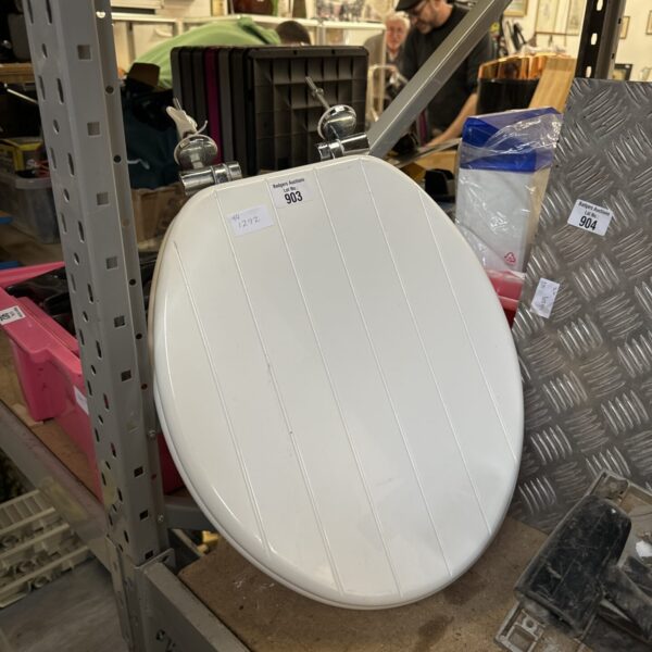Vintage wooden toilet seat, a classic retro bathroom fixture.