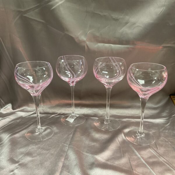 Set of four vintage Caithness Crystal wine glasses on display.