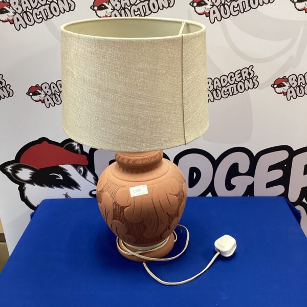 Large terracotta Cyprus table lamp with a warm glow.