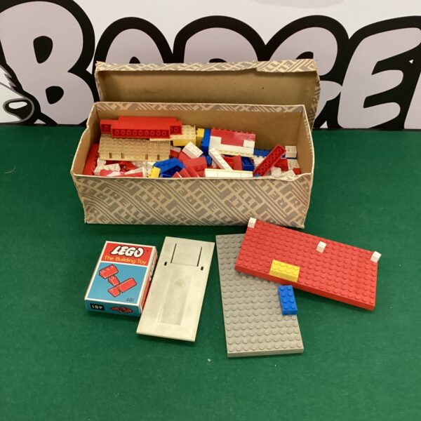 Assorted vintage Lego bricks in a box, classic building toy.