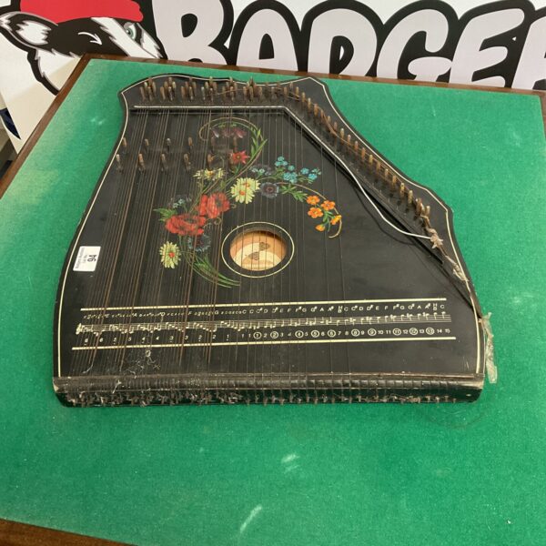 Vintage Musima zither with floral decoration, a classic folk instrument.