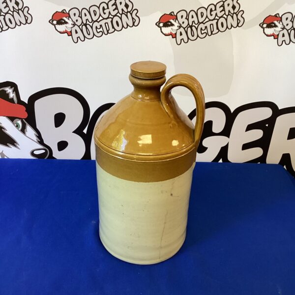 Vintage earthenware flagon with a rustic aesthetic.
