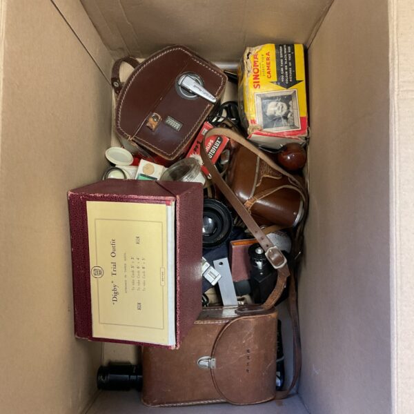 Vintage camera collection with cases and accessories.