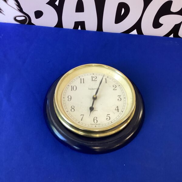 Vintage Baskerville kitchen clock with white enamel face.