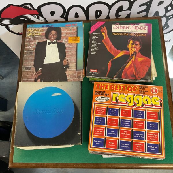 Vintage vinyl record collection featuring Status Quo and Michael Jackson albums.