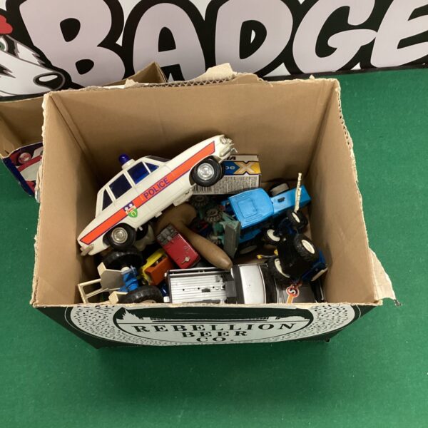 Toy car lot featuring a Tomy police car and assorted vehicles.