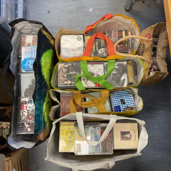 Large collection of music CDs in bags.