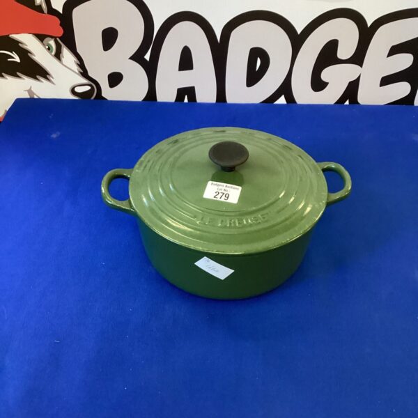 Green Le Creuset No. 22 casserole dish with lid.