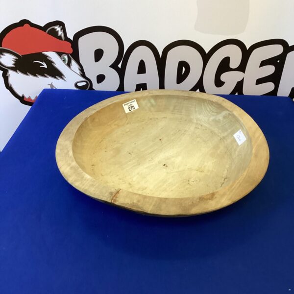 Large carved wooden platter for serving food and rustic decor.