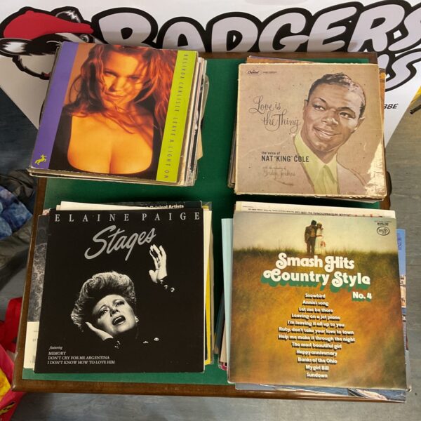 Vintage vinyl record lot with colourful album covers.