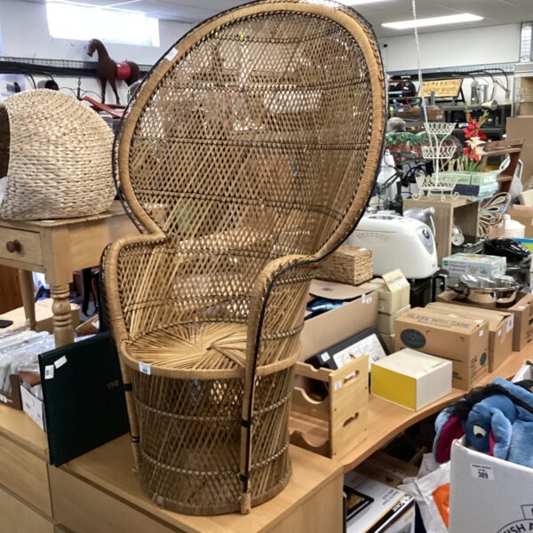 Vintage wicker peacock chair with detailed rattan weaving.
