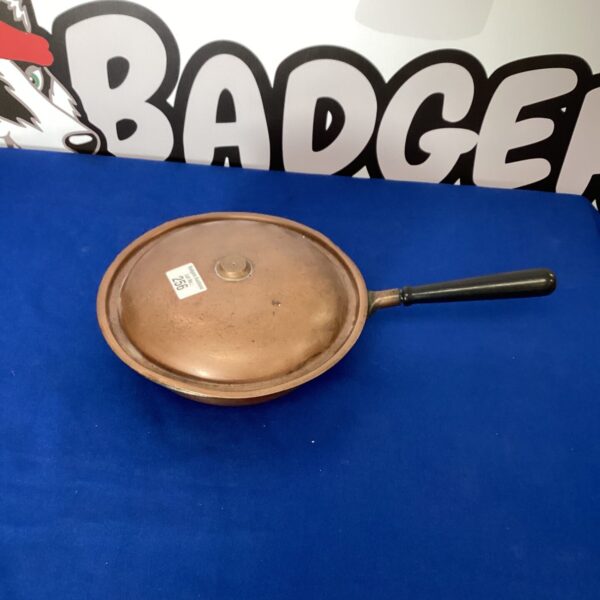 Vintage copper pan with cast iron handle, antique kitchenware.