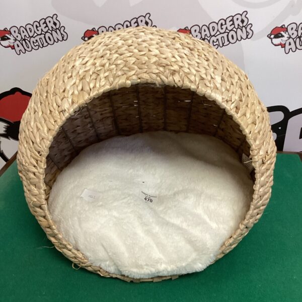 Round woven bullrush cat bed with cream lining.