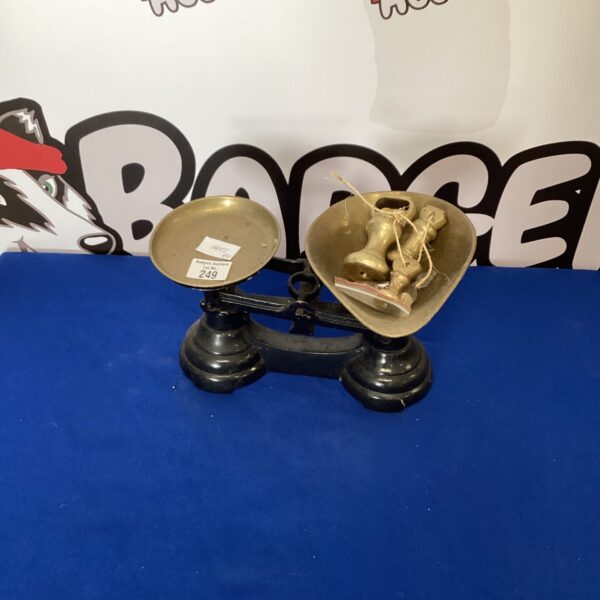 Vintage brass kitchen scales with weights for accurate measurement.
