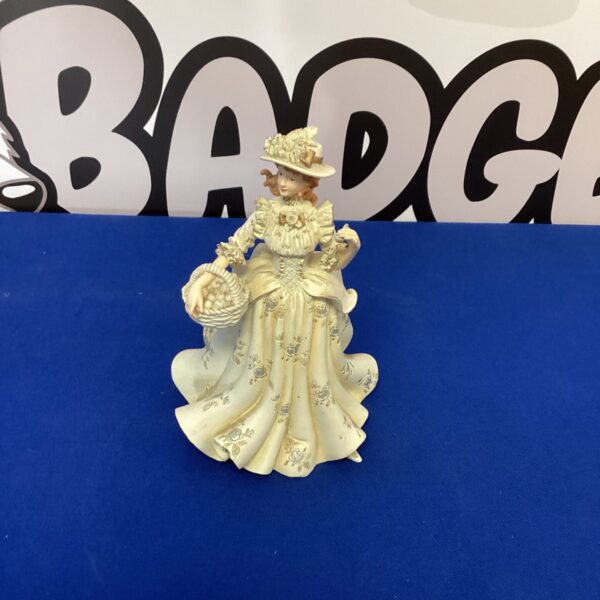 Vintage Regency Fine Arts porcelain lady figurine with basket.