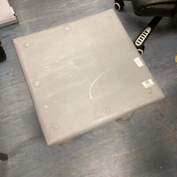 Small grey square side table with a vintage aesthetic.