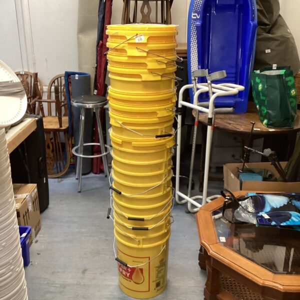 Stack of yellow plastic storage buckets for home and garden use.