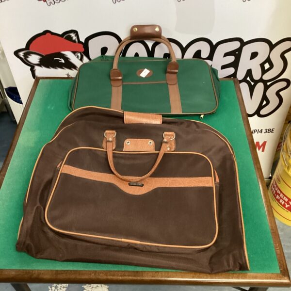 Vintage green Revaluation suit bag with handle.