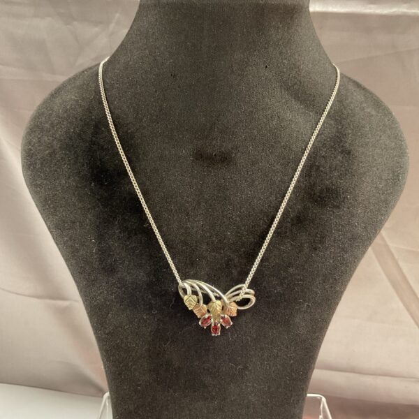 Vintage Art Nouveau silver necklace with red stone pendant.