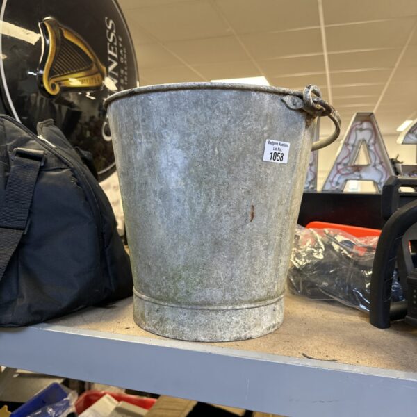 Front view of a vintage galvanised bucket with contents.