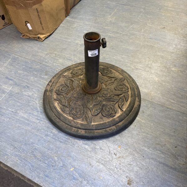 Vintage cast iron garden parasol stand with English rose detail.