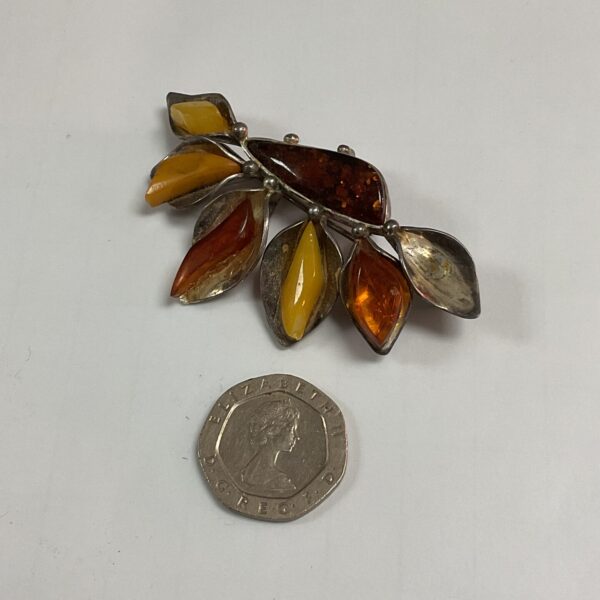 Vintage silver and amber floral brooch with missing bead.