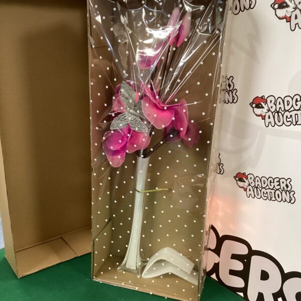 Tall silk flower arrangement in a clear vase for home decor.